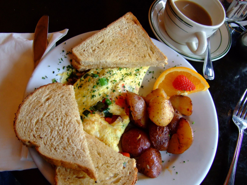 Breakfast of omelette, potatoes and toast